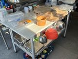 a kitchen with a table that has pots and pans on it