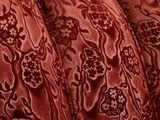 close up of a red couch with a floral pattern on it