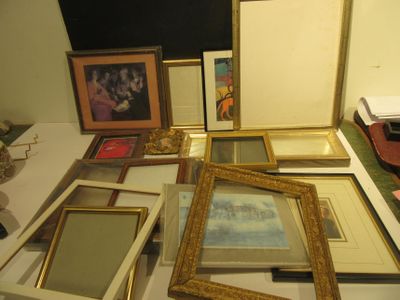 a lot of picture frames sitting on a table