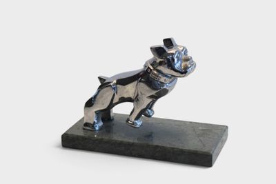 statue of a dog with a top hat on a marble base