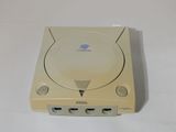 an old nintendo game console sitting on top of a white table