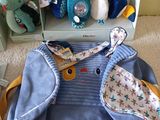 a blue bag with a stuffed animal and a stuffed elephant