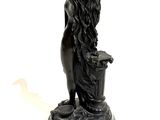 statue of a woman holding a bucket of water on a pedestal