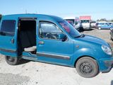 a small blue van parked in a parking lot