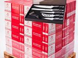 a stack of red boxes with a knife on top of it