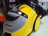 a yellow and gray steam cleaner on a white table