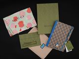 four different types of gucci wallets on a black background