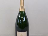 the bottle of champagne is sitting on the table next to the wall