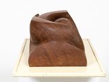 an image of a wooden sculpture on a white pedestal