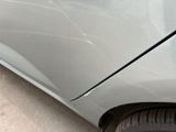 a close up of a car that has a denting on the side of it
