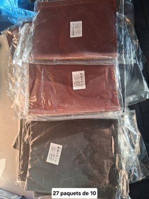 three bags of brown, red, and green cloth sitting on top of a table