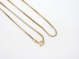 a gold chain with a clasp on a white background