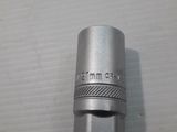 a close up of a small metal object on a white surface