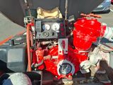 a red fire hydrant sitting on the back of a truck