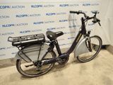 a bicycle that is parked in front of a wall