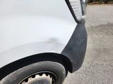 a close up of a white truck with a black rim