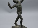 statue en bronze représentant un garçon sur un socle en marbre, la main levée