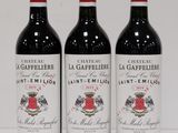 three bottles of wine sitting on top of a white table