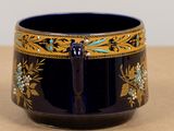 a close up of a blue bowl with gold and blue decorations