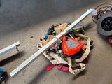 a pile of assorted items on the floor in a garage