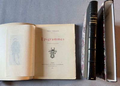 two books and a pen on a table next to each other