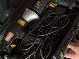 a person holding a drill in a tool box