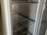 an open refrigerator in the corner of a room