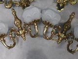 a lot of gold and white lamps on a table