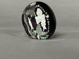 black and green glass ring with a silhouette of a woman holding a knife