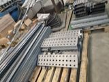 a large pile of steel bars on a pallet in a warehouse