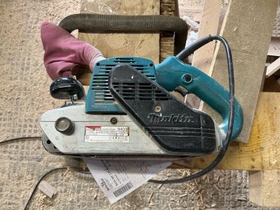 a person using a chainsaw to cut a piece of wood