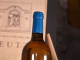 a bottle of wine sitting on a table next to a book