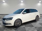 the white car is parked on a checkered floor in a room