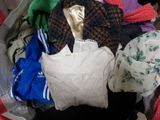 a bag full of clothes that is sitting on the floor