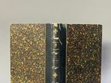 a close up of a book on a table with a white background