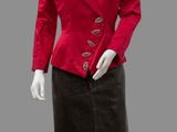 a mannequin wearing a red jacket and black skirt