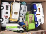 a cardboard box filled with toy cars and trucks