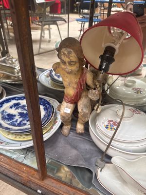 a display case with plates and a lamp on it