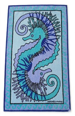 a blue and purple rug with a seahorse on it