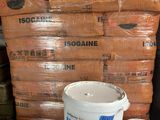 several buckets of cement sitting on top of a table next to a pile of bags