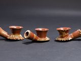 three small vases are sitting next to each other on a black surface