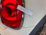 a close up of a car tail light with a sticker on it