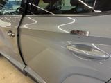 a car that has been painted silver and has a sticker on the door