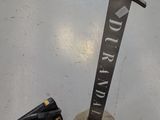 a sword that is sitting on the floor next to a bag