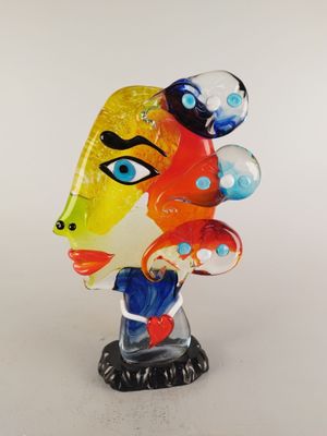 a close up of a glass sculpture of a woman ' s face