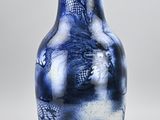 a blue and white vase with a dragon design on it