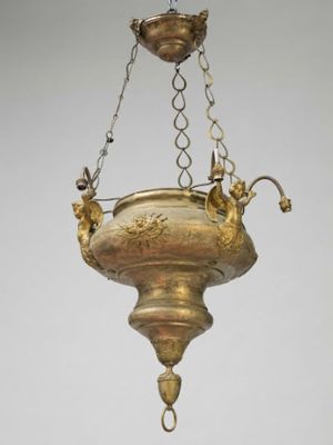 an image of a brass hanging light fixture with a bird on it