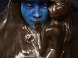 bronze statue of a woman holding a child with a crown on her head
