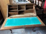 an old desk with a blue top in a room