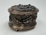 a silver box with a design on it on a white surface